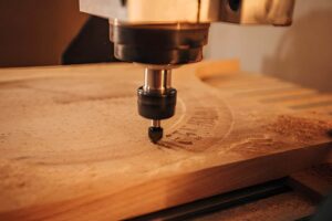 CNC engraving machine making a pattern on a wood sheet