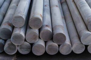 Close-up of Stacked Aluminum Billets and Cylindrical Metal Rods