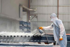 Man painting metal bars