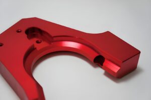 A red color anodized aluminum machined part