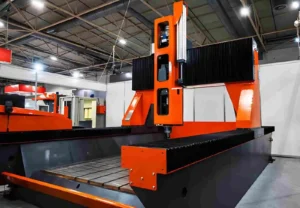Powerful orange and black CNC machine in an industrial setting. It showcases automated manufacturing technology for precision metalworking or material processing