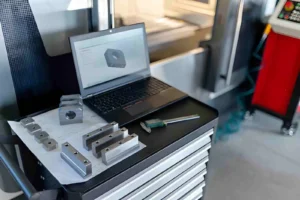 Precision Machined Metal Components with Laptop and CAD Software